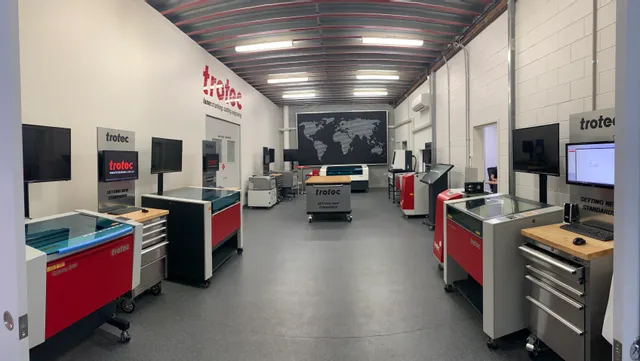 Trotec showroom with Speedy series CO₂ laser cutters and Ruby software workstations