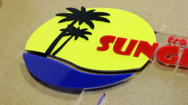 Laser-cut acrylic sign with palm trees and SUNG text made using Trotec laser cutter