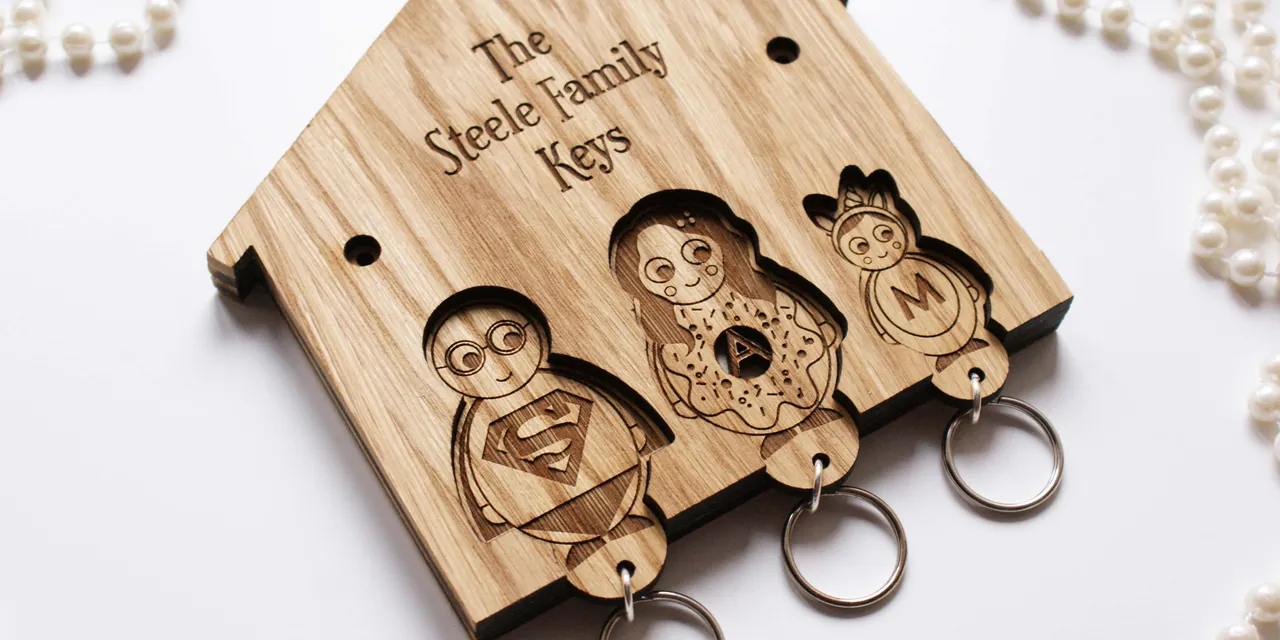 Wooden key holder engraved with cartoon characters using Trotec laser cutter