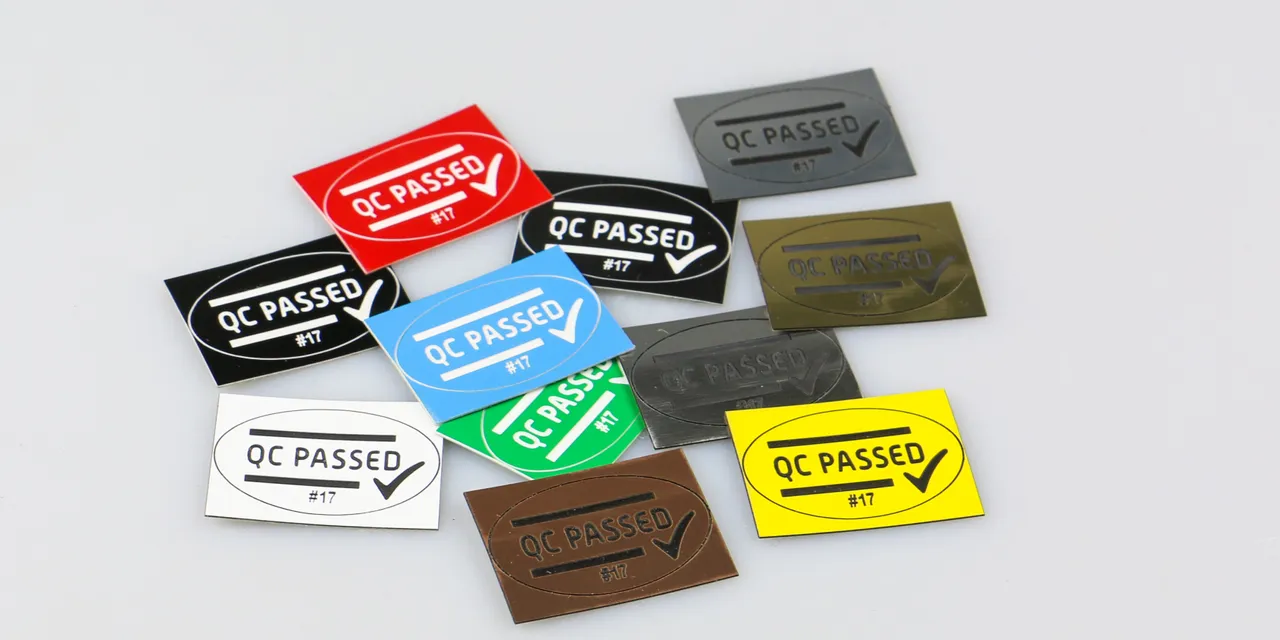 Colorful QC Passed labels laser engraved with Trotec laser marking technology