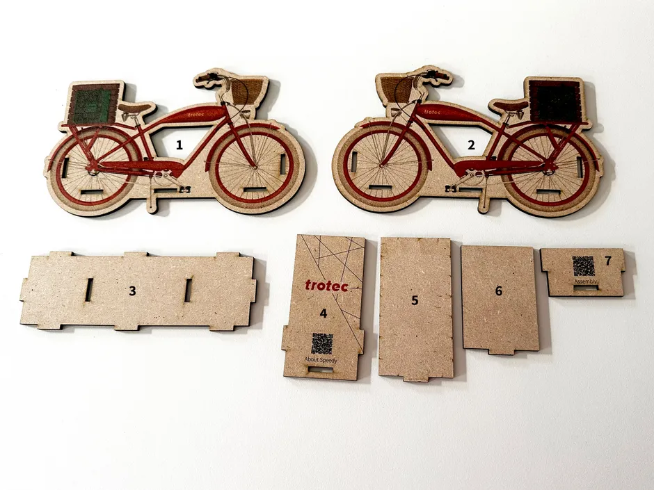Laser-cut wooden bicycle kit parts created with Trotec Speedy series CO₂ laser engraver