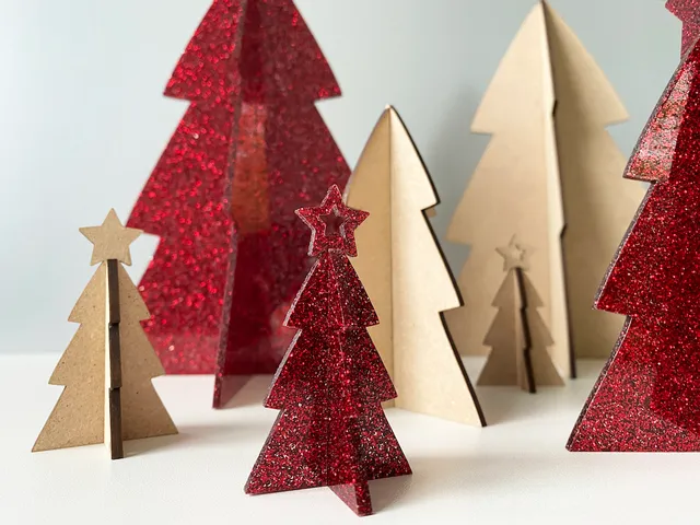 Laser-cut glitter and wood holiday trees made with Trotec laser cutter