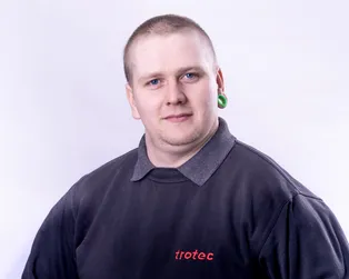 Trotec staff member wearing branded uniform, supporting laser engraving and cutting solutions